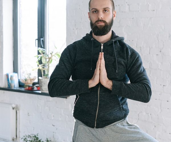 Man in a calm, focused pose after a workout session.